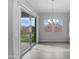 Bright dining area featuring sliding glass doors to backyard and a window with backyard views at 41285 W Sussex Dr, Maricopa, AZ 85138