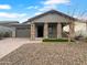 Charming single-story home with stone accents and a well-manicured front yard with desert landscaping at 41285 W Sussex Dr, Maricopa, AZ 85138