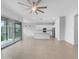 Bright living room offering ample space, tile floors, modern lighting, and large sliding doors to the outdoors at 41285 W Sussex Dr, Maricopa, AZ 85138