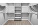 Spacious walk-in closet with ample shelving and metal racks for organized storage at 41285 W Sussex Dr, Maricopa, AZ 85138