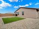 Backyard featuring gravel landscaping, artificial turf, and a covered patio at 4336 N 93Rd Dr, Phoenix, AZ 85037