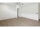 Bright bedroom with wood-look floors, a ceiling fan, and neutral walls at 4336 N 93Rd Dr, Phoenix, AZ 85037