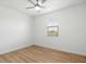 Bedroom featuring wood-look floors, a ceiling fan and a window at 4336 N 93Rd Dr, Phoenix, AZ 85037
