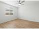 A minimalist bedroom includes a modern ceiling fan and a bright window at 4336 N 93Rd Dr, Phoenix, AZ 85037