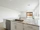 Kitchen island features a stainless steel sink, dishwasher, and granite countertop at 4336 N 93Rd Dr, Phoenix, AZ 85037
