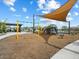 Community playground with swings, climbing structure, and covered picnic area for outdoor fun at 4336 N 93Rd Dr, Phoenix, AZ 85037
