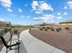 Serene community walking path with bench seating and desert landscaping for leisurely strolls and relaxation at 4336 N 93Rd Dr, Phoenix, AZ 85037