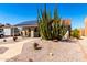 Charming single-story home with desert landscaping, paved walkway and solar panels at 614 W Morrow Dr, Phoenix, AZ 85027