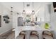 Modern kitchen with white cabinets, stainless steel appliances, quartz countertops, and breakfast bar at 614 W Morrow Dr, Phoenix, AZ 85027