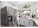 Kitchen showcases stainless steel appliances, white cabinets, and a decorative wall plant at 614 W Morrow Dr, Phoenix, AZ 85027