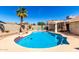 Sparkling pool with palm tree, lounge chairs, umbrella, and covered patio in backyard at 614 W Morrow Dr, Phoenix, AZ 85027