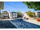 Charming backyard featuring a paved patio, storage shed, and comfortable seating area with a fire pit at 6814 N 11Th St, Phoenix, AZ 85014