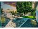 Relaxing backyard boasts a manicured lawn, paved patio, and cozy seating arrangement with a fire pit at 6814 N 11Th St, Phoenix, AZ 85014