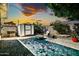 Charming backyard featuring a paved patio, storage shed, and comfortable seating area with a fire pit at 6814 N 11Th St, Phoenix, AZ 85014
