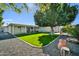 Large backyard with lush lawn and gravel area with access to home and patio space at 6814 N 11Th St, Phoenix, AZ 85014