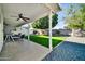 Covered patio featuring ceiling fan, lush lawn, and gravel hardscape at 6814 N 11Th St, Phoenix, AZ 85014