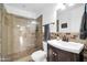 Bathroom featuring a glass-enclosed shower with decorative tile, dark wood vanity, and contemporary fixtures at 6814 N 11Th St, Phoenix, AZ 85014