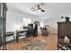 Open bedroom with desk, ceiling fan, neutral-toned walls, sitting area, and a comfortable bed perfect for relaxation at 6814 N 11Th St, Phoenix, AZ 85014