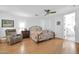 Bright bedroom with a comfortable bed, neutral-toned walls, modern ceiling fan, and convenient access to the en-suite bathroom at 6814 N 11Th St, Phoenix, AZ 85014
