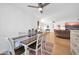 Bright dining area with white and brown table set, ceiling fan, and view into living room at 6814 N 11Th St, Phoenix, AZ 85014