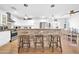 Open kitchen with white cabinets, stone countertops, a breakfast bar, and stainless steel appliances at 6814 N 11Th St, Phoenix, AZ 85014