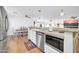 Open kitchen featuring stainless steel appliances, white cabinets, eat-in breakfast bar, and modern fixtures at 6814 N 11Th St, Phoenix, AZ 85014