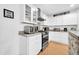 Bright kitchen featuring stainless steel appliances, white cabinets, and stone countertops at 6814 N 11Th St, Phoenix, AZ 85014