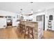 Bright kitchen with stainless steel appliances, white cabinets, stone breakfast bar, and modern pendant lights at 6814 N 11Th St, Phoenix, AZ 85014