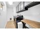 Efficient laundry room with modern black appliances, ample storage cabinets, and a functional wooden folding table at 6814 N 11Th St, Phoenix, AZ 85014