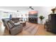 Cozy living room with ceiling fan, electric fireplace, entertainment center, and leather reclining sectional sofa at 6814 N 11Th St, Phoenix, AZ 85014