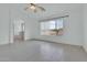 Bright bedroom featuring tile flooring, a ceiling fan, and window with natural light at 7325 W Williams St, Phoenix, AZ 85043