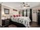 Well-lit bedroom featuring a ceiling fan, two windows with blinds, neutral-toned walls, and a bed with patterned coverlet at 757 S 82Nd Way, Mesa, AZ 85208