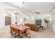 Open living and dining area with a vaulted ceiling, chandelier, and large leather sofa at 8126 E Vista Bonita Dr, Scottsdale, AZ 85255