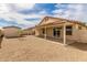 Home's backyard with covered patio, low maintenance landscaping, shed, and convenient access to the home at 8541 N 112Th Ave, Peoria, AZ 85345