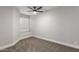 Bright bedroom highlights a ceiling fan, window with shutters, and neutral tones at 8541 N 112Th Ave, Peoria, AZ 85345