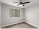 Bedroom featuring neutral carpeting, a ceiling fan, and a window at 8541 N 112Th Ave, Peoria, AZ 85345