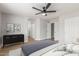 Bedroom featuring a ceiling fan, modern decor, and access to a ensuite bathroom at 8541 N 112Th Ave, Peoria, AZ 85345