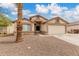 Inviting single-story home with desert landscaping, a spacious driveway, and an attached two-car garage at 8541 N 112Th Ave, Peoria, AZ 85345