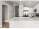 Bright kitchen featuring white cabinets, quartz countertops, stainless appliances, and an open layout at 8541 N 112Th Ave, Peoria, AZ 85345