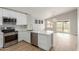 Stylish kitchen with white cabinets, quartz countertops, stainless steel appliances, and wood-look flooring at 8541 N 112Th Ave, Peoria, AZ 85345