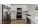 Modern kitchen showcasing stainless steel appliances, white cabinets, and quartz countertops at 8541 N 112Th Ave, Peoria, AZ 85345