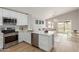 Bright kitchen with white cabinets, stainless steel appliances, and an open concept to the living and dining areas at 8541 N 112Th Ave, Peoria, AZ 85345