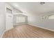 Bright living room with vaulted ceilings, wood-look floors, and a decorative front door with sidelight window at 8541 N 112Th Ave, Peoria, AZ 85345