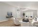 Staged living room with modern decor, wood floors, and ample seating area at 8541 N 112Th Ave, Peoria, AZ 85345