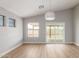 Light-filled living room features wood-look flooring and a sliding door leading to the backyard at 8541 N 112Th Ave, Peoria, AZ 85345