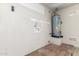 Utility room or unfinished basement features an old hot water heater at 8541 N 112Th Ave, Peoria, AZ 85345