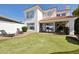 Expansive backyard with a putting green, covered patio, and well-maintained landscaping at 9390 N 115Th St, Scottsdale, AZ 85259