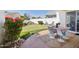 Outdoor dining area on patio with a putting green and lush landscaping at 9390 N 115Th St, Scottsdale, AZ 85259