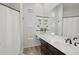 Bathroom with dark vanity, large mirror, and a glass block window for lots of natural light at 9390 N 115Th St, Scottsdale, AZ 85259