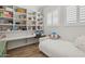 Bedroom with a built-in desk and shelving unit and a shuttered window for natural light at 9390 N 115Th St, Scottsdale, AZ 85259